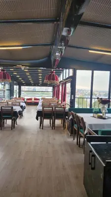 a dining room with tables and chairs and windows at Lale Sultan Hotel in Istanbul