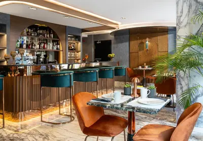 a restaurant with a bar with tables and chairs at Nex Hotel & Spa Istanbul in Istanbul