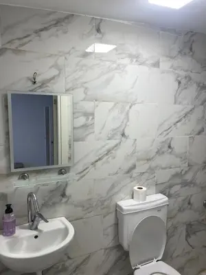 a white bathroom with a sink and a toilet at HOTEL YEDİkapı in Istanbul