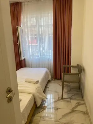 a room with a bed and a chair and a window at HOTEL YEDİkapı in Istanbul