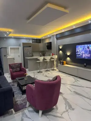 a living room with purple chairs and a flat screen tv at Sapanca Villa View Suite in Sapanca
