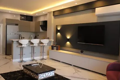 a living room with a flat screen tv on a wall at Sapanca Villa View Suite in Sapanca