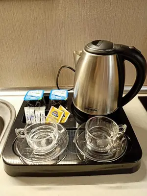 a tea pot and dishes on a tray on a stove at NEW FALCON Palas OTEL in Istanbul
