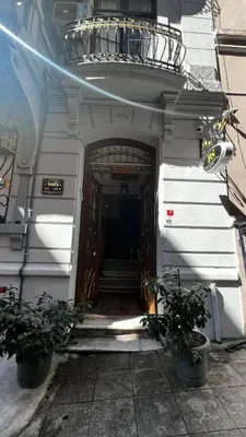 a door to a building with two potted plants at Bali Star City Hotel in Istanbul