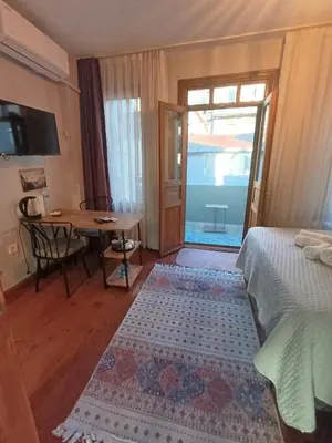 a bedroom with a bed and a table and a table at NarPera Taksim Boutique Hotel in Istanbul