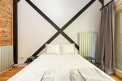 a large bed in a room with a brick wall at Warm Rustic Charming 2BD Galata wPatio Gem! #320 in Istanbul