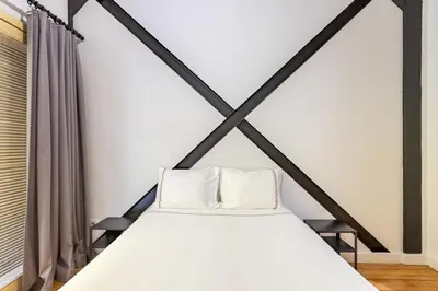 a bedroom with a large bed with white sheets at Warm Rustic Charming 2BD Galata wPatio Gem! #320 in Istanbul