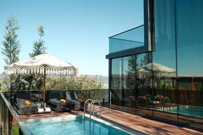 a house with a swimming pool next to a building at Velour Hotel Spa Restaurant in Sakarya