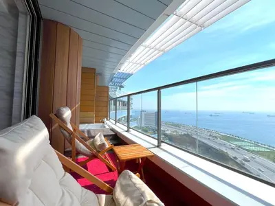 a room with a balcony with a view of the ocean at Exquisite Ottomare Suites in Istanbul