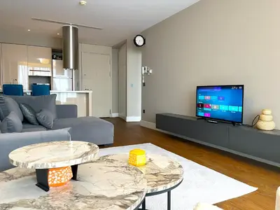 a living room with a couch and a tv at Exquisite Ottomare Suites in Istanbul