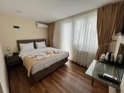 a bedroom with a bed and a large window at Taksim Nacre 360 Suit in Istanbul