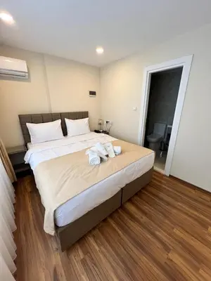 a bedroom with a large bed with towels on it at Taksim Nacre 360 Suit in Istanbul