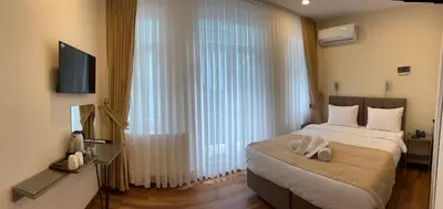 a bedroom with a bed and a large window at Taksim Nacre 360 Suit in Istanbul