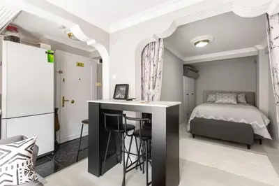 a bedroom with a bed and a desk with a table at Practical and Cozy Flat Near Taksim İstikal in Istanbul