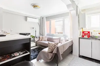a living room with a couch and a table at Practical and Cozy Flat Near Taksim İstikal in Istanbul