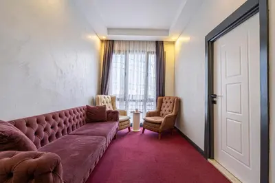 a living room with a couch and two chairs at Süper Stay Halkalı in Istanbul