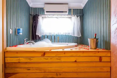 a bath tub sitting on top of a wooden dresser in a bathroom at Süper Stay Halkalı in Istanbul
