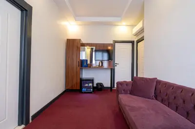 a living room with a couch in a room at Süper Stay Halkalı in Istanbul