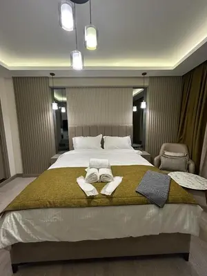 a bedroom with a large bed with two towels on it at Palma Suites in Istanbul