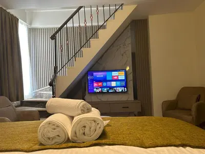 a hotel room with a bed with towels and a tv at Palma Suites in Istanbul