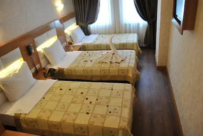 a hotel room with three beds in it at Hotel Star Park in Istanbul