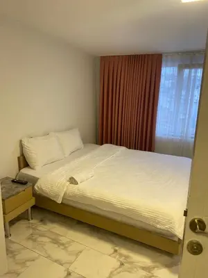 a large bed in a bedroom with a window at YENİkapı in Istanbul
