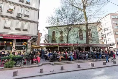 a crowd of people sitting in chairs on a city street at Duplex Modern City Gem with Terrace in Istanbul