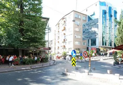 a city street with a group of people sitting on the sidewalk at Stylish Duplex in Beyoğlu with Private Terrace in Istanbul