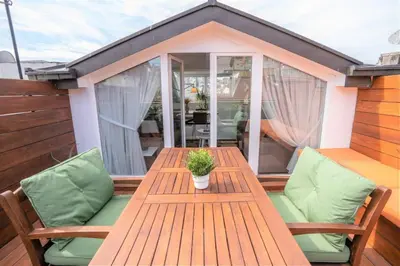 a wooden table and chairs on a deck at Stylish Duplex in Beyoğlu with Private Terrace in Istanbul