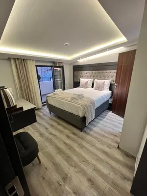 a hotel room with a bed and a chair at Golden Stoneluxe İstanbul Hotel in Istanbul