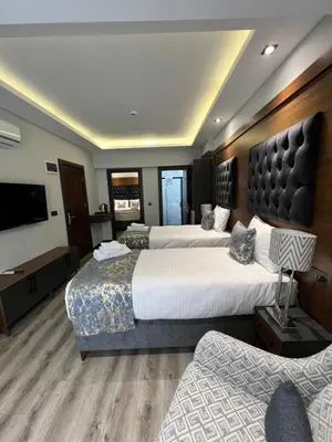 a hotel room with two beds and a flat screen tv at Golden Stoneluxe İstanbul Hotel in Istanbul
