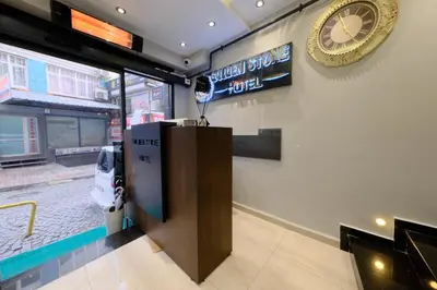 a room with a reception desk and a clock on the wall at Golden Stoneluxe İstanbul Hotel in Istanbul