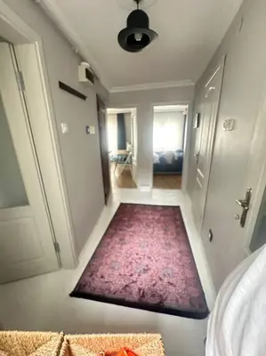 a hallway with a rug on the floor of a room at 5 Min Walk Distance Taksim Square Semi Sea View in Istanbul
