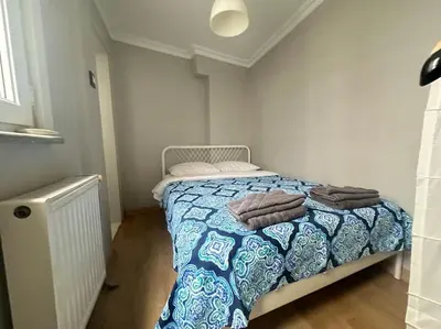 a bedroom with a bed with towels on it at 5 Min Walk Distance Taksim Square Semi Sea View in Istanbul