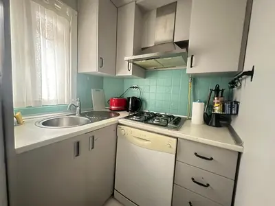 a small kitchen with white cabinets and a sink at 5 Min Walk Distance Taksim Square Semi Sea View in Istanbul