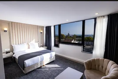 a hotel room with a bed and a large window at Moss Hotel YENİKAPI in Istanbul