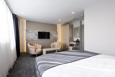 a hotel room with a bed and two chairs at Moss Hotel YENİKAPI in Istanbul