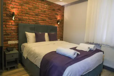 a bedroom with a bed with two towels on it at Yellow Mansion in Istanbul