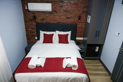 a bedroom with a large bed with red pillows at Yellow Mansion in Istanbul