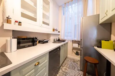 a kitchen with white counters and a refrigerator at Elegant, spacious, quiet 3br near historic center in Istanbul