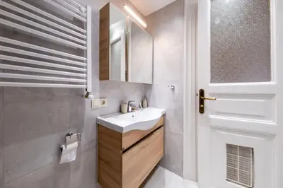 a bathroom with a white sink and a mirror at Elegant, spacious, quiet 3br near historic center in Istanbul