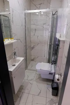 a bathroom with a shower and a toilet and a sink at Pera Apart in Istanbul