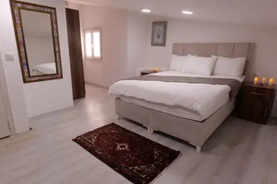 a bedroom with a bed with a mirror and a rug at Pera Apart in Istanbul
