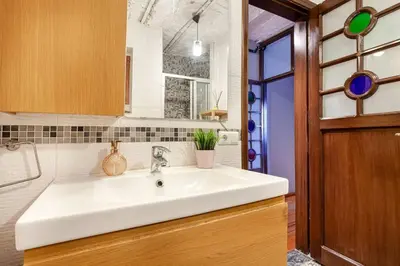 a kitchen with a white sink and a wooden door at Magnificent view, in the center in Istanbul