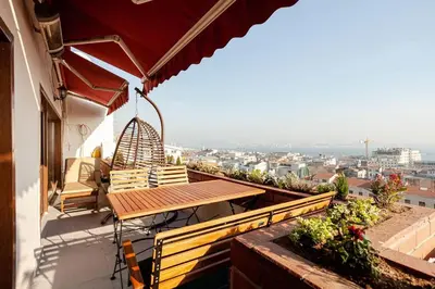a patio with a table and chairs on a balcony at Magnificent view, in the center in Istanbul