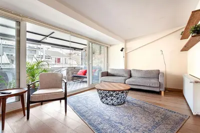 a living room with a couch and a table at Prime location with terrace in Istanbul