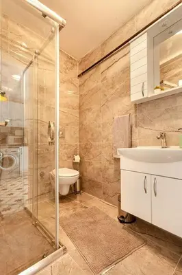 a bathroom with a shower and a sink and a toilet at Prime location with terrace in Istanbul