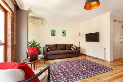 a living room with a couch and a tv at Central location with 2 bedrooms in Istanbul
