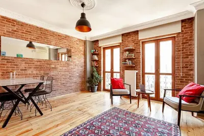 a living room with a brick wall and a table and chairs at Central location with 2 bedrooms in Istanbul