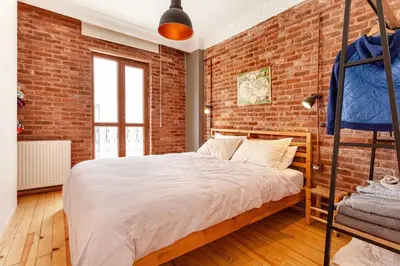 a bedroom with a brick wall and a bed at Central location with 2 bedrooms in Istanbul